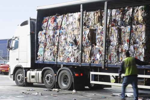 Happy customers loading their skip container in Hounslow.